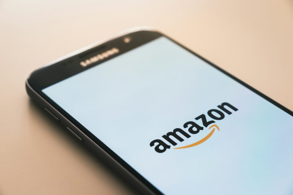 black smartphone displaying Amazon logo. AWS